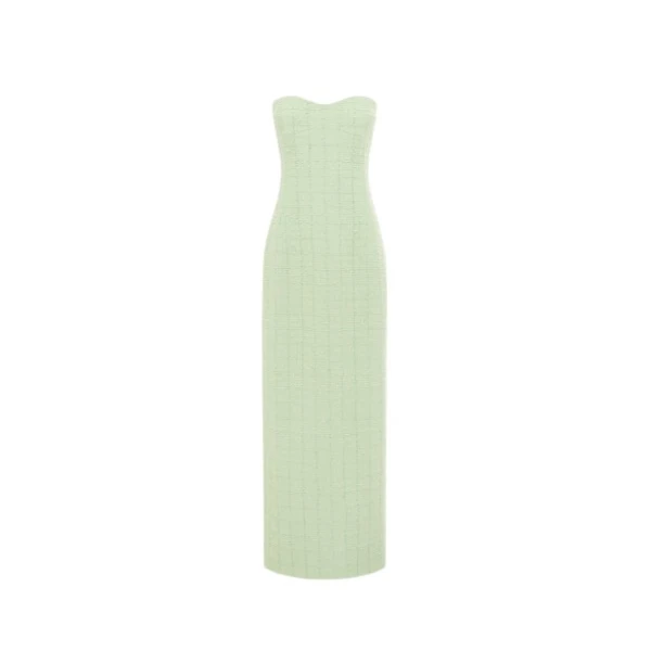 Leo Lin Zayna tweed bustier maxi dress in a light green color, featuring a strapless boned bodice, a fitted waist, and a gently flared skirt with a high slit, modeled by a person with light brown hair posing gracefully.