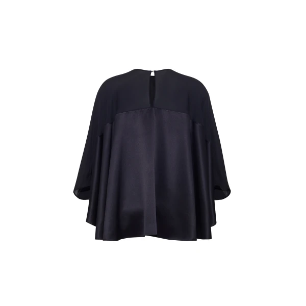 the Apollo Top is crafted from luxurious 100% silk in a timeless black hue. The flowing
