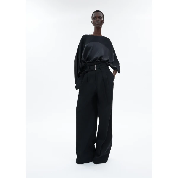 draped design features a high-neck collar and a cascading silhouette