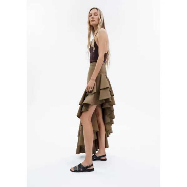 this skirt adds dynamic movement and texture. The high-waisted fit and expertly placed ruffles make it a statement piece that effortlessly transitions from day to night.