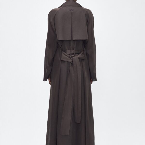 color Ebony. The Jupiter Trench is crafted from lightweight cotton organdy