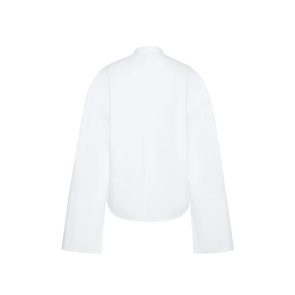 the Mick Top is crafted from crisp organic cotton poplin in classic white. The top features a tie closure at the center front