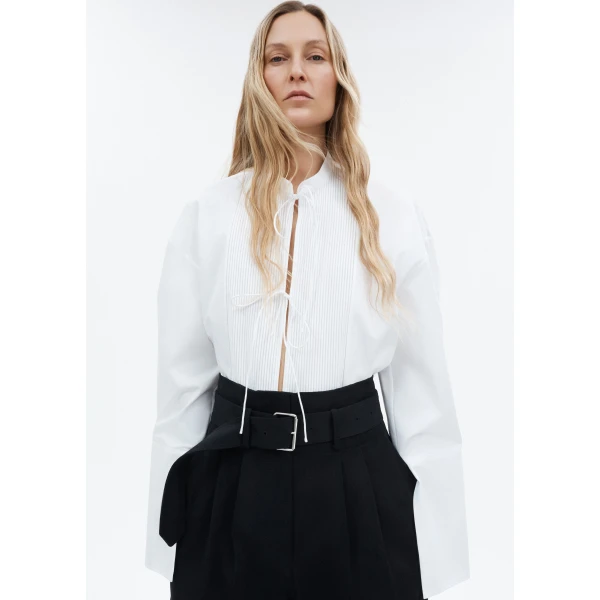 adding a subtle touch of modern sophistication. Billowy sleeves with split cuffs create an airy and elegant silhouette. Includes a silk cami for added comfort and versatility.
