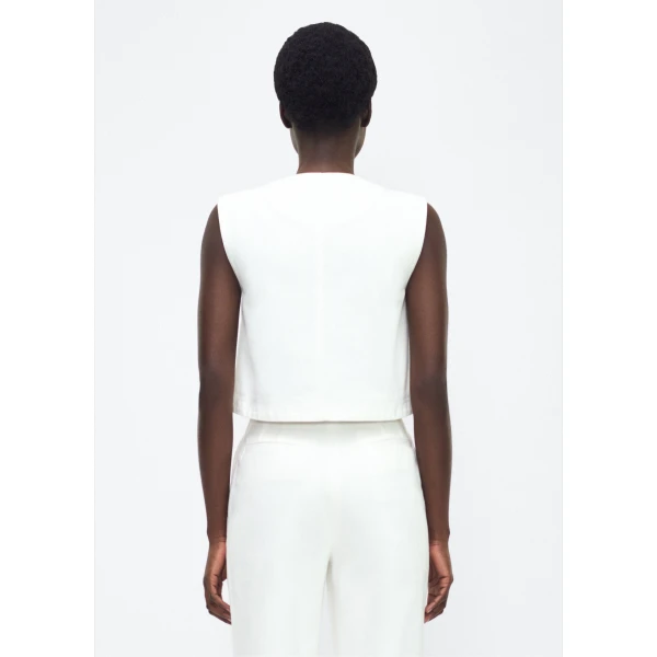 P25 collection: This Italian white denim top features elegant silver buttons cast with our iconic diamond monogram along the center front. Pair with the Dakota Skirt in White Denim for a complete look.