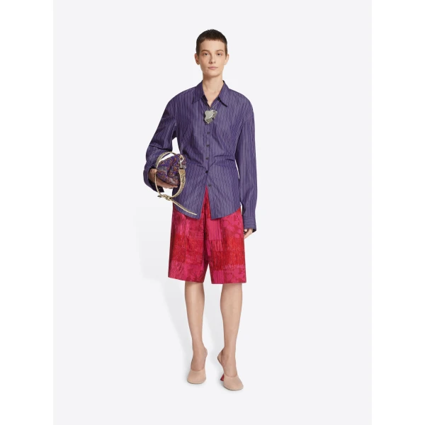 in striped cotton poplin. Can be worn closed all the way down or styled halfway buttoned.