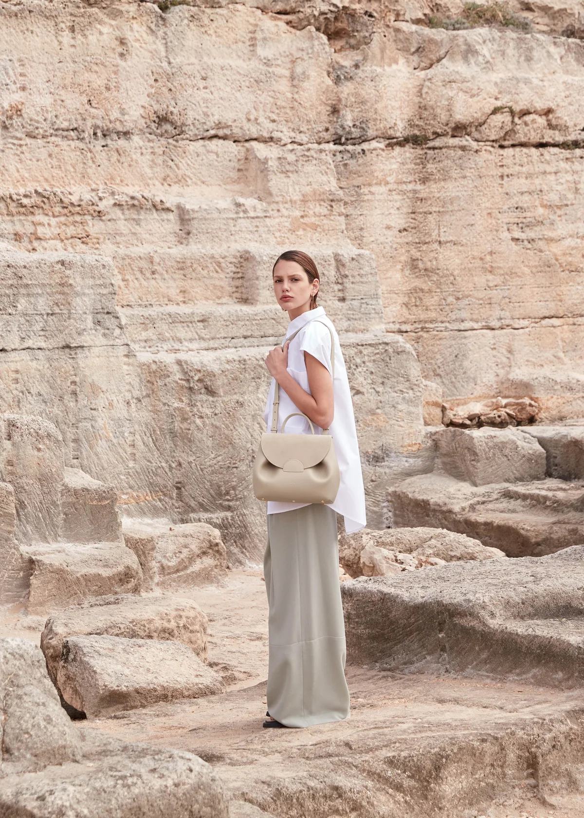 Sand Polène Numéro Un Mini bag styled with jeans and sneakers