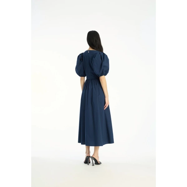 Rotate Blue from  Luxury Handbags – bold silhouette in vibrant color