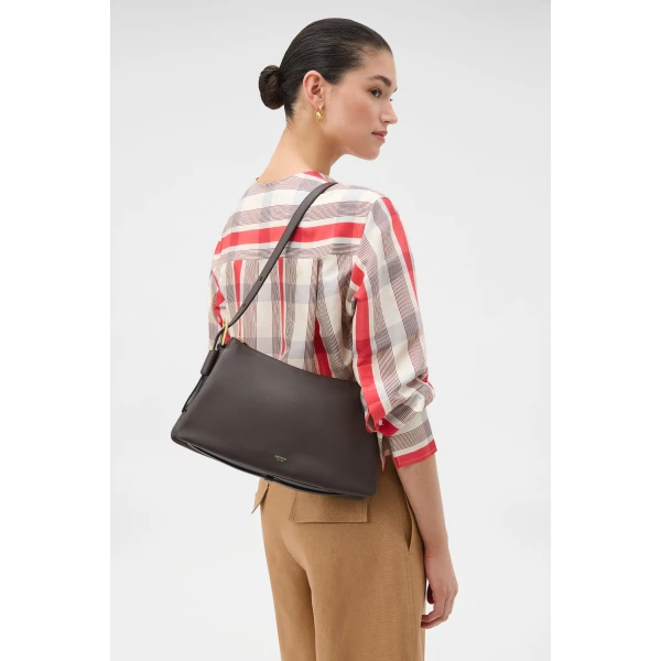 Profile view of model wearing the Oroton CALI SHOULDER BAG in DARK CHOCOLATE and Premium smooth leather for Women