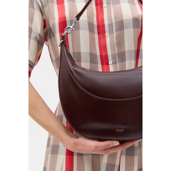 Profile view of model wearing the Oroton FLORENCE MEDIUM HOBO in COPPER and Premium crackle leather for Women