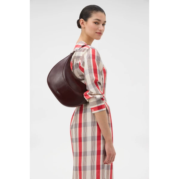 Profile view of model wearing the Oroton FLORENCE MEDIUM HOBO in COPPER and Premium crackle leather for Women
