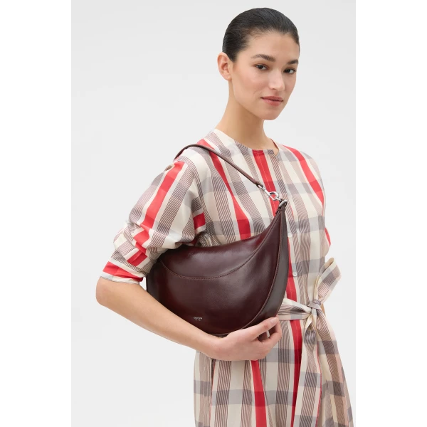 Profile view of model wearing the Oroton FLORENCE MEDIUM HOBO in COPPER and Premium crackle leather for Women