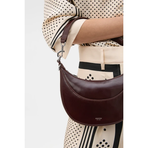 Profile view of model wearing the Oroton FLORENCE SMALL SHOULDER BAG in COPPER and Premium crackle leather for Women