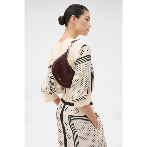 Profile view of model wearing the Oroton FLORENCE SMALL SHOULDER BAG in COPPER and Premium crackle leather for Women