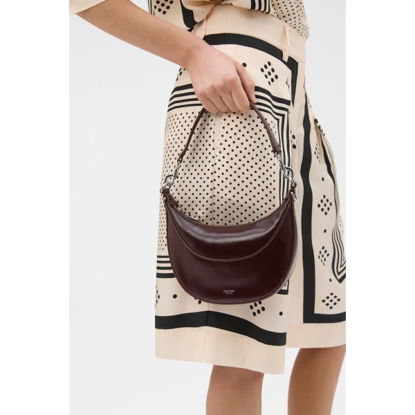 Profile view of model wearing the Oroton FLORENCE SMALL SHOULDER BAG in COPPER and Premium crackle leather for Women