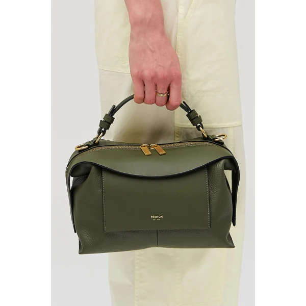 Profile view of model wearing the Oroton MICA BOWLER in Dark Khaki and Premium pebble grain leather for Women