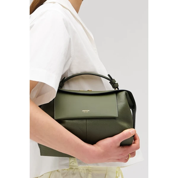 Profile view of model wearing the Oroton MICA BOWLER in Dark Khaki and Premium pebble grain leather for Women