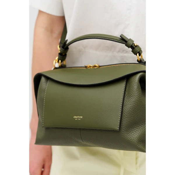 Profile view of model wearing the Oroton MICA BOWLER in Dark Khaki and Premium pebble grain leather for Women