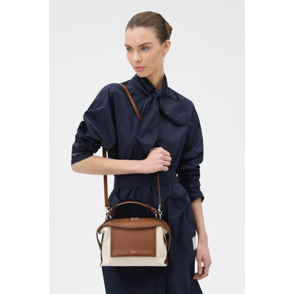 Profile view of model wearing the Oroton MICA BOWLER CANVAS BROGUING in NATURAL/PENNY BROWN and Premium canvas material for Women