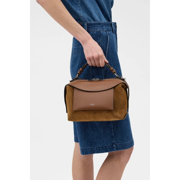 Profile view of model wearing the Oroton MICA BOWLER SUEDE in TEAK and Premium suede leather for Women