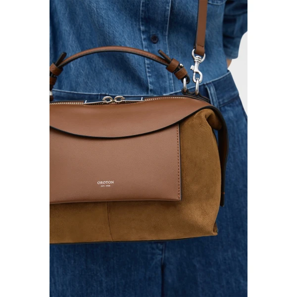 Profile view of model wearing the Oroton MICA BOWLER SUEDE in TEAK and Premium suede leather for Women