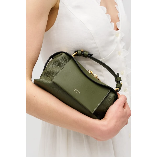 Profile view of model wearing the Oroton MICA MINI BOWLER in Dark Khaki and Premium pebble leather for Women