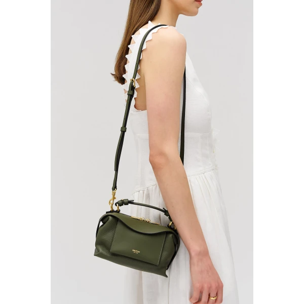 Profile view of model wearing the Oroton MICA MINI BOWLER in Dark Khaki and Premium pebble leather for Women