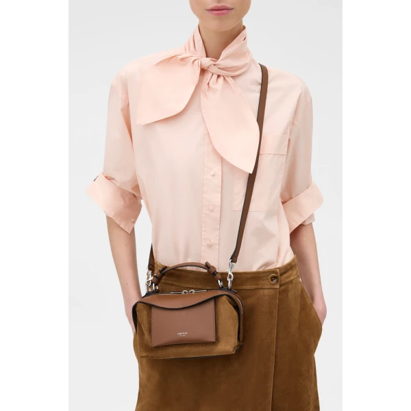Profile view of model wearing the Oroton MICA MINI BOWLER SUEDE in TEAK and Premium suede leather for Women