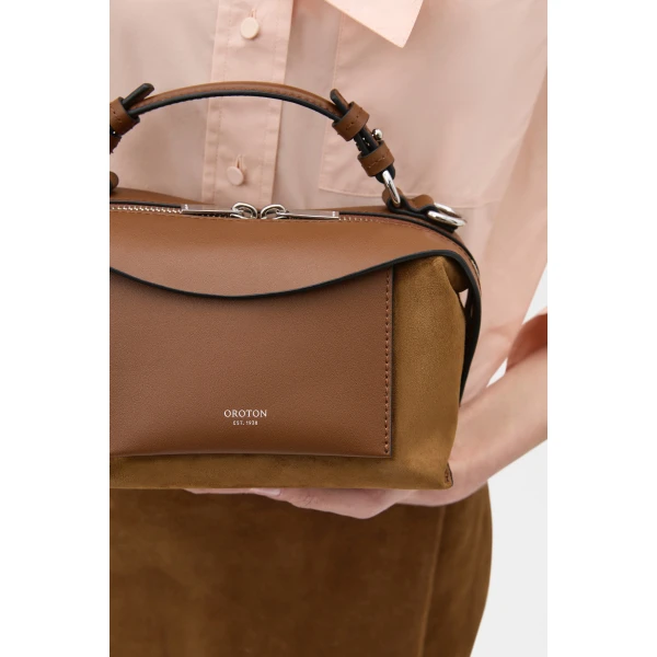 Profile view of model wearing the Oroton MICA MINI BOWLER SUEDE in TEAK and Premium suede leather for Women