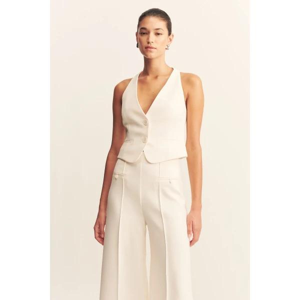 High waisted pant with a wide flare in a textured crepe fabrication.