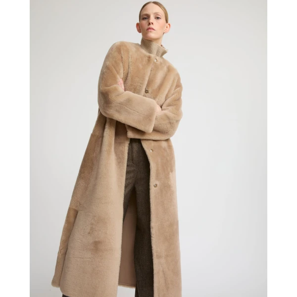 Woman wearing Yves Salomon shearling fur coat – luxury outerwear at Luxury Shoes 