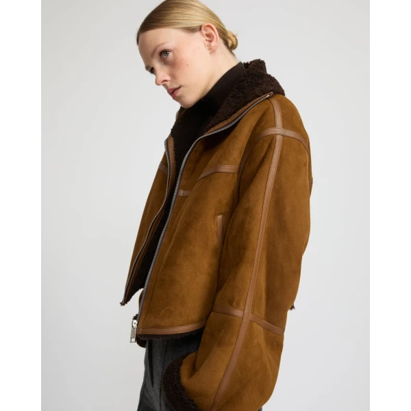 Woman wearing Yves Salomon shearling fur coat – luxury outerwear at Luxury Shoes 