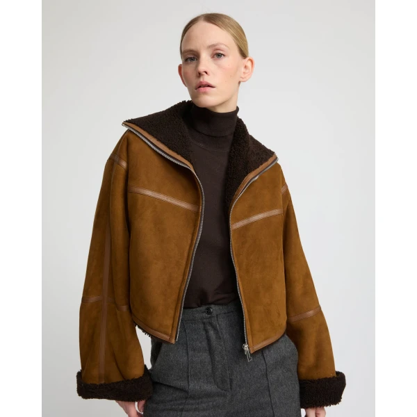 Woman wearing Yves Salomon shearling fur coat – luxury outerwear at Luxury Shoes 