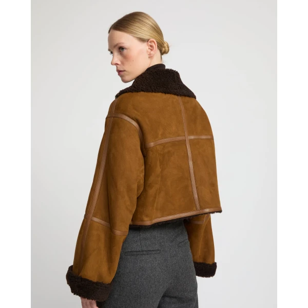 Woman wearing Yves Salomon shearling fur coat – luxury outerwear at Luxury Shoes 
