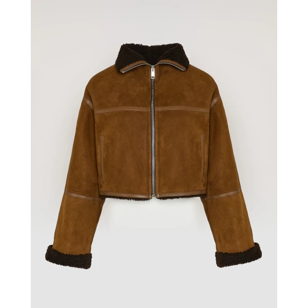 Woman wearing Yves Salomon shearling fur coat – luxury outerwear at Luxury Shoes 