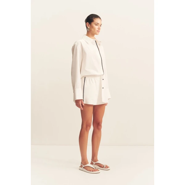 Long sleeve shirt in a white organic cotton poplin with black contrast binding.