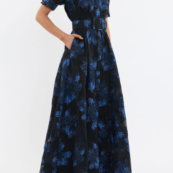 its relaxed silhouette is refined with a concealed placket and side seam pockets. A self-belt cinches the waist to flatter the figure