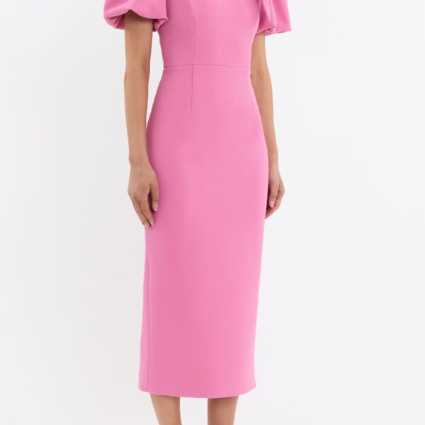 its rounded neckline and fitted bodice are elevated by an asymmetrical draped bow detail for a touch of refined charm. Cinched at the waist