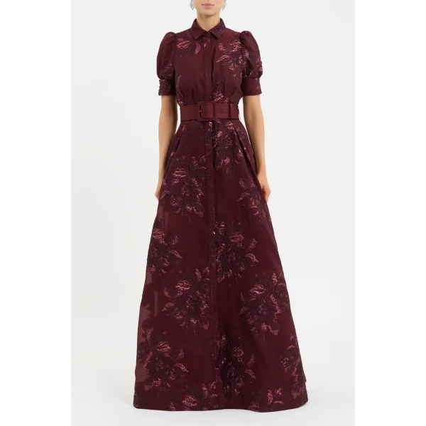 tailored from brocade. Its refined collared neckline and short puff sleeves with cuff detailing strike the perfect balance of modern sophistication and timeless elegance. A self-belt cinches waist