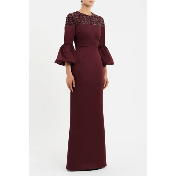 the fitted bodice seamlessly complements the crew neckline and long sleeves with puff detailing to sculpt an elegant shape. Cinched at the waist
