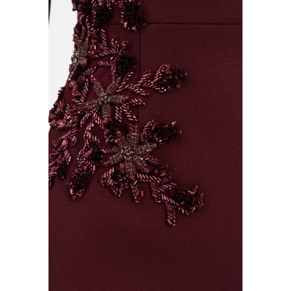 accentuated by princess seams and shoulder pads for a refined finish. Cinched at the waist