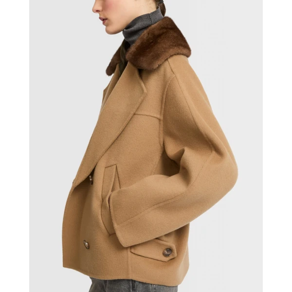 Woman wearing Yves Salomon shearling fur coat – luxury outerwear at Luxury Shoes 