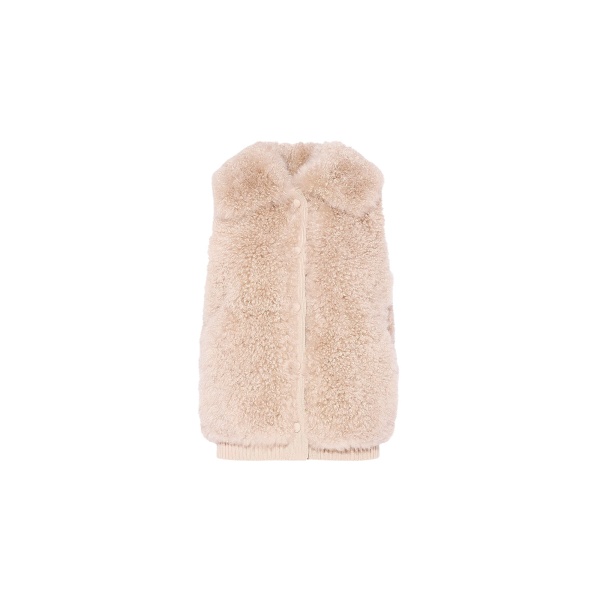 Woman wearing Yves Salomon shearling fur coat – luxury outerwear at Luxury Shoes 