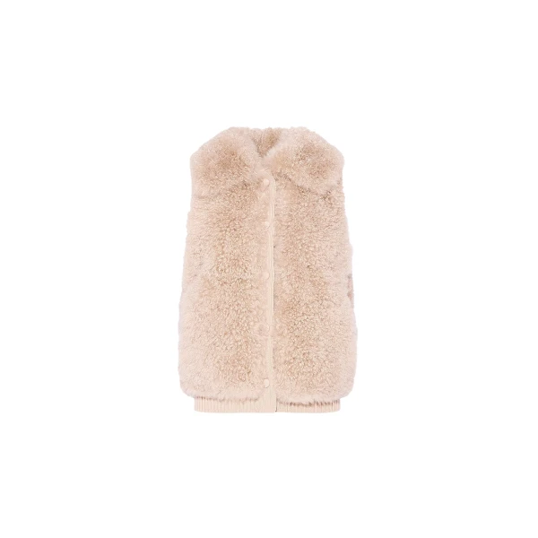 Woman wearing Yves Salomon shearling fur coat – luxury outerwear at Luxury Shoes 