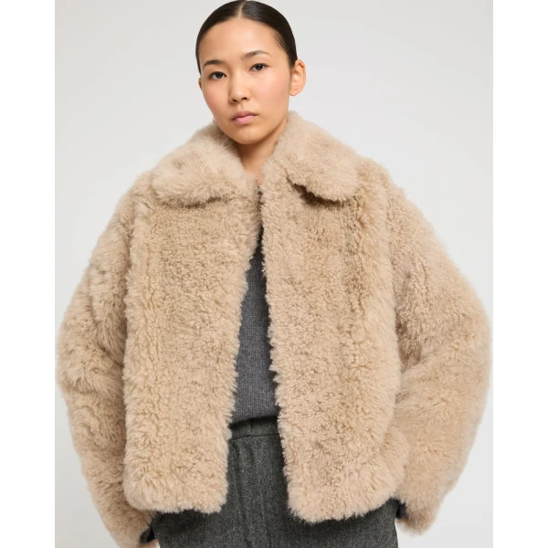 Woman wearing Yves Salomon shearling fur coat – luxury outerwear at Luxury Shoes 