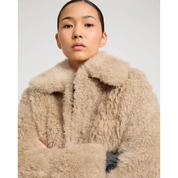 Woman wearing Yves Salomon shearling fur coat – luxury outerwear at Luxury Shoes 