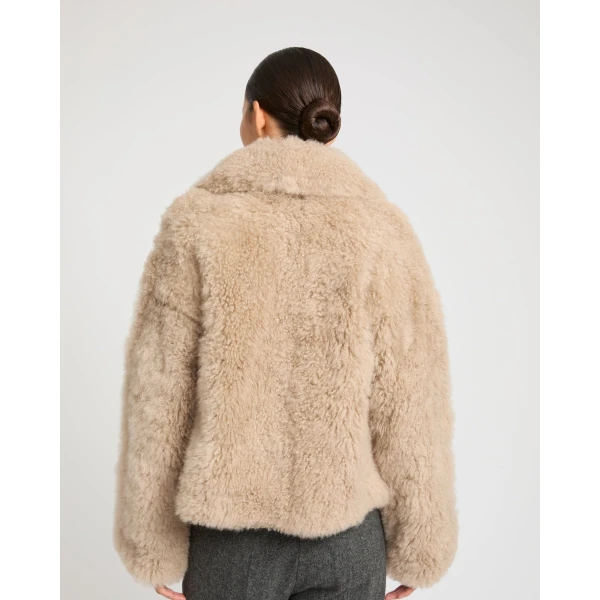 Woman wearing Yves Salomon shearling fur coat – luxury outerwear at Luxury Shoes 