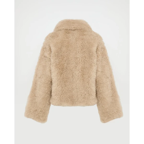 Woman wearing Yves Salomon shearling fur coat – luxury outerwear at Luxury Shoes 