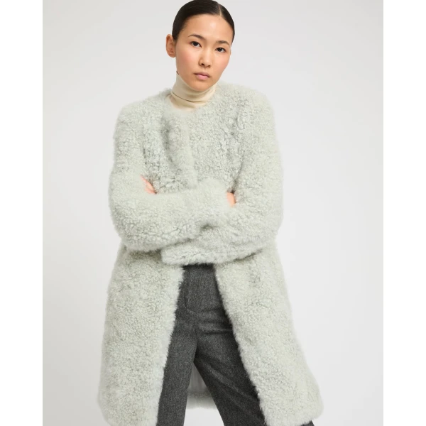 Woman wearing Yves Salomon shearling fur coat – luxury outerwear at Luxury Shoes 