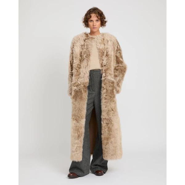 Woman wearing Yves Salomon shearling fur coat – luxury outerwear at Luxury Shoes 