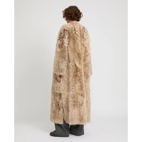 Woman wearing Yves Salomon shearling fur coat – luxury outerwear at Luxury Shoes 